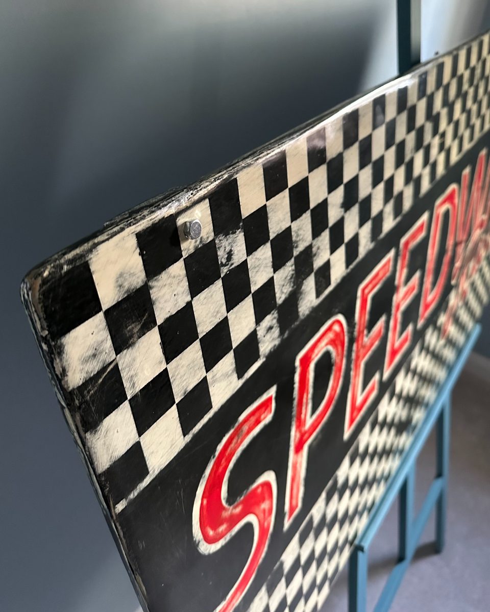 Speedway sign — top edge perspective showing depth